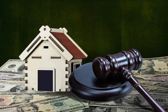 Gavel and model home representing real estate litigation