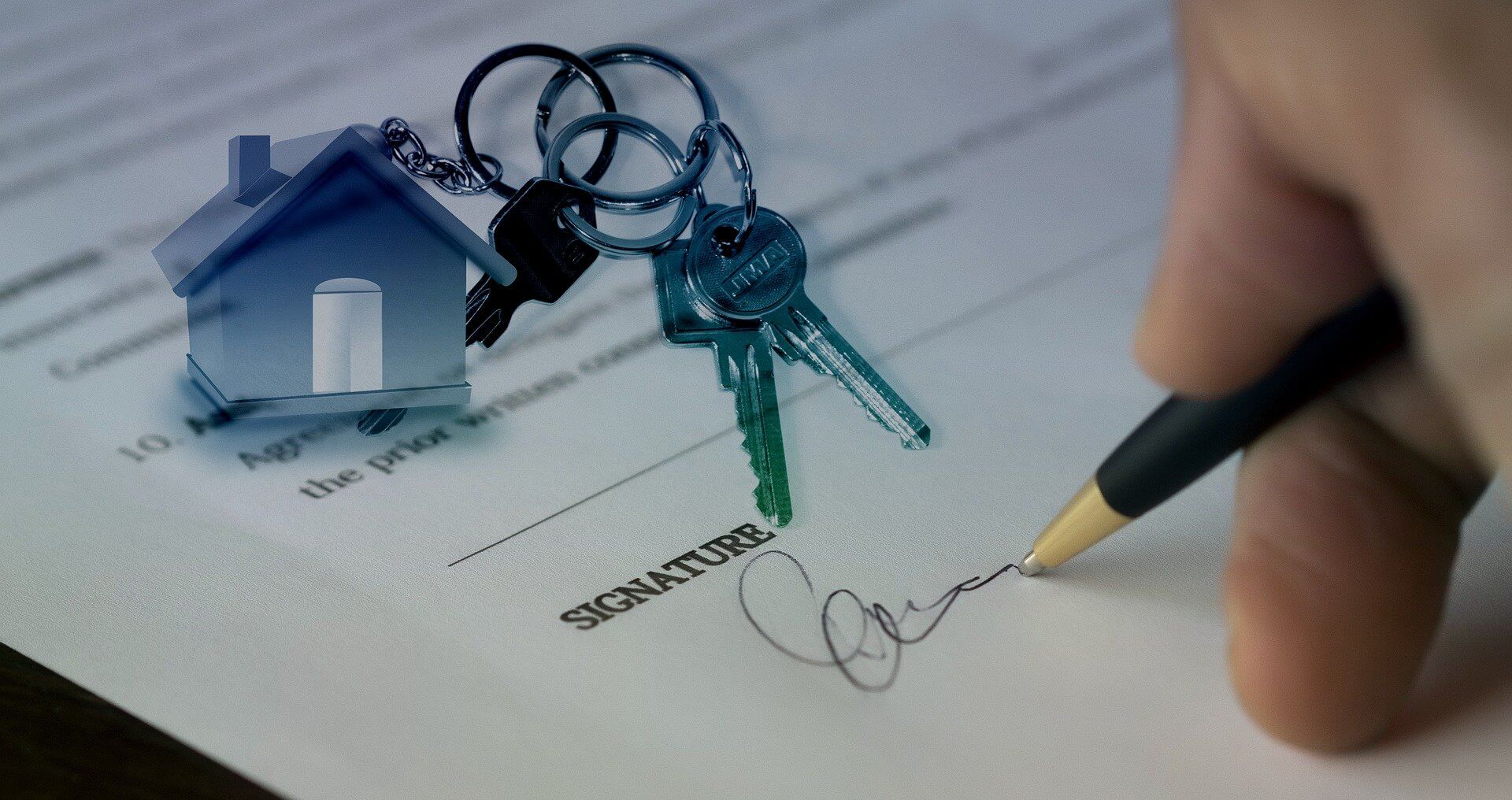 Signing a real estate purchase agreement with house keys